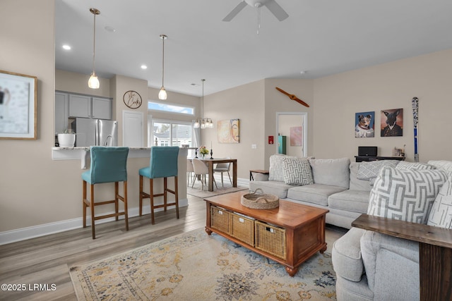 living room featuring ceiling fan and light wood-type flooring