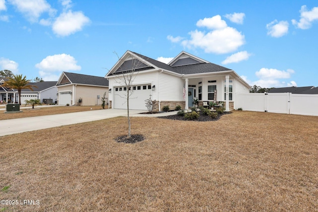 craftsman-style home with a porch, a garage, and a front yard