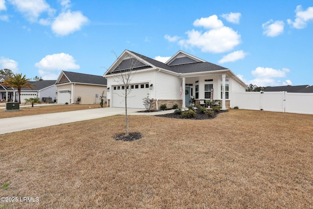 craftsman-style home with a porch, a garage, and a front yard