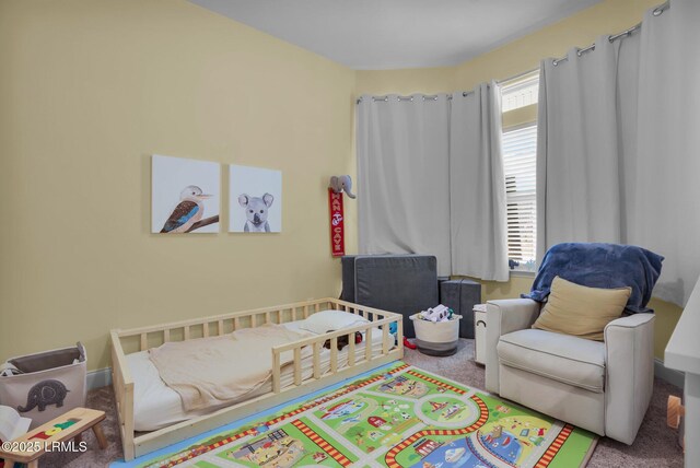 bedroom with multiple windows and light carpet