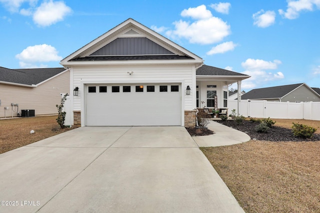 craftsman inspired home with a garage, a porch, a front yard, and central air condition unit