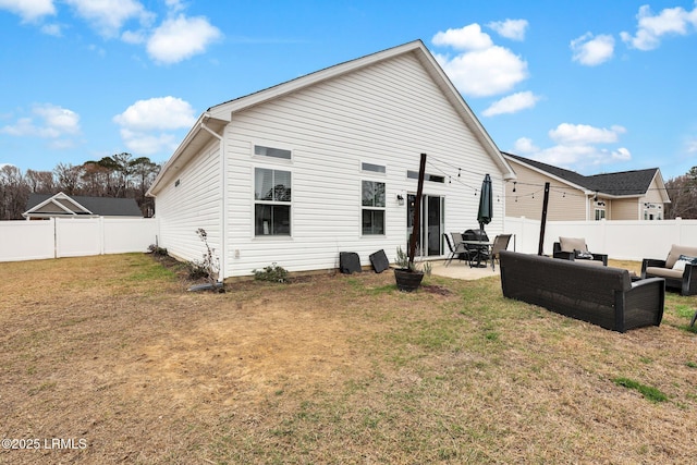 rear view of property featuring a patio, an outdoor hangout area, and a lawn