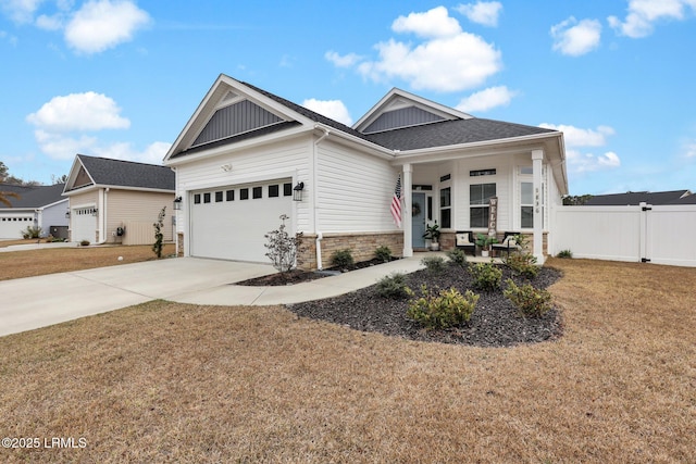 craftsman-style house featuring a garage, a front lawn, and a porch