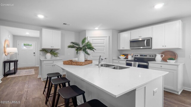 1595 Sanctum St, Ridgeland, SC 29936 - kitchen featuring appliances with stainless steel finishes, a sink, a breakfast bar area, recessed lighting, and dark wood finished floors
