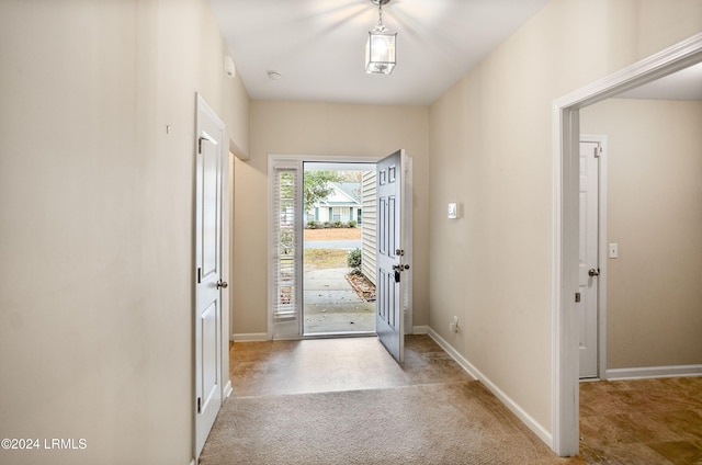 entryway featuring light colored carpet