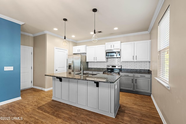 4944 Tidal Walk Ln, Beaufort, SC 29907 - kitchen featuring stainless steel appliances, a center island with sink, decorative backsplash, dark wood-type flooring, and a kitchen bar