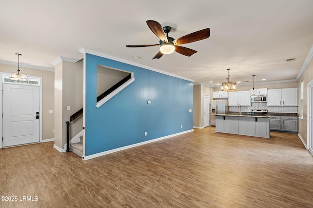 4944 Tidal Walk Ln, Beaufort, SC 29907 - unfurnished living room featuring crown molding, light wood-type flooring, ceiling fan, stairway, and recessed lighting