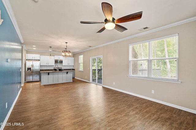 4944 Tidal Walk Ln, Beaufort, SC 29907 - unfurnished living room with crown molding, wood finished floors, a ceiling fan, and a chandelier