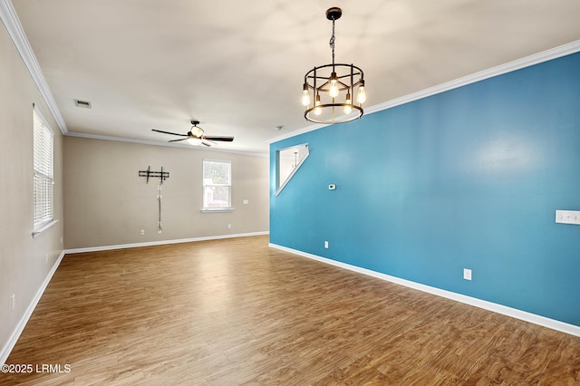 4944 Tidal Walk Ln, Beaufort, SC 29907 - spare room with crown molding, ceiling fan, wood finished floors, and a chandelier