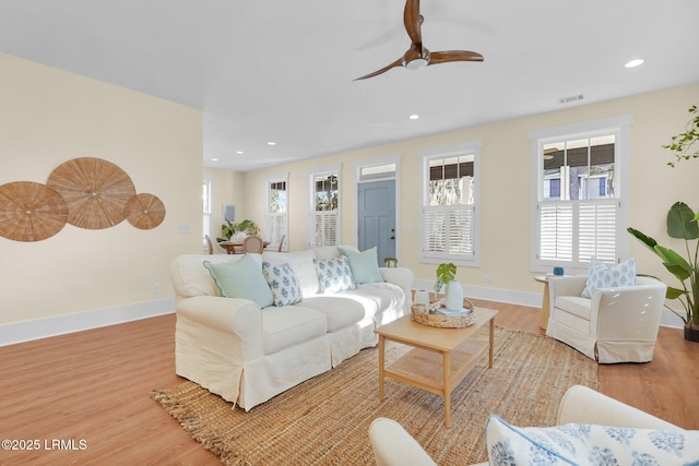 living area with recessed lighting, wood finished floors, and baseboards