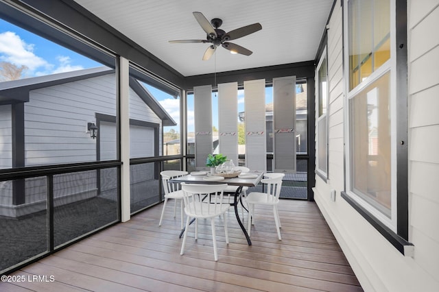 sunroom featuring ceiling fan and a wealth of natural light