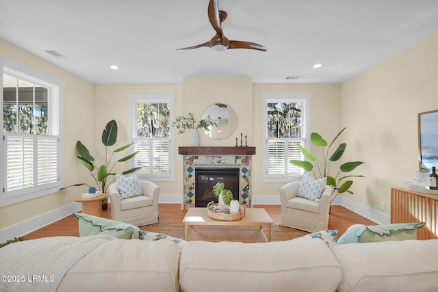 living area featuring plenty of natural light, wood finished floors, and recessed lighting