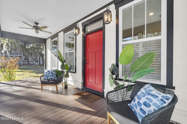 property entrance featuring covered porch, concrete block siding, and a ceiling fan