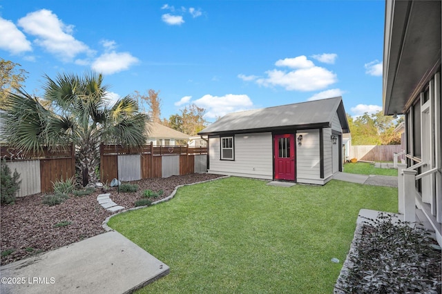 view of yard featuring a fenced backyard and an outbuilding