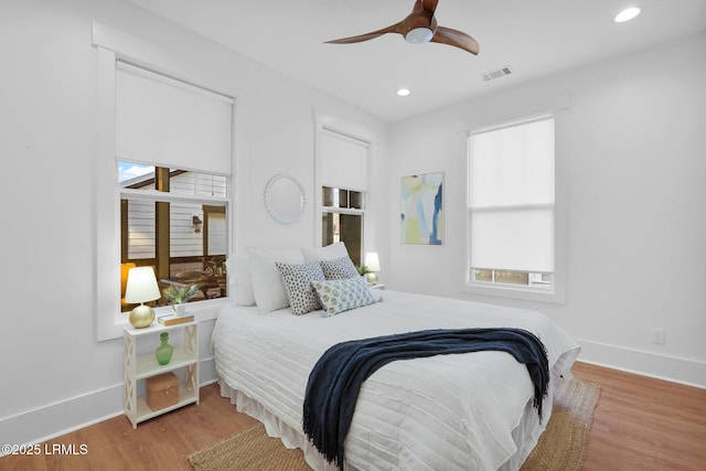 bedroom featuring recessed lighting, visible vents, a ceiling fan, wood finished floors, and baseboards