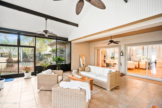 interior space with ceiling fan, plenty of natural light, and vaulted ceiling with beams