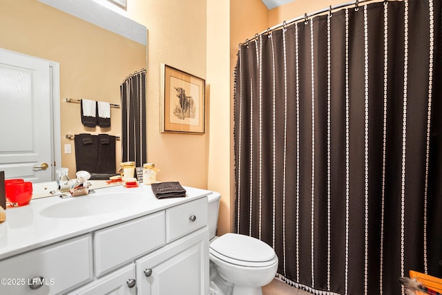 bathroom featuring vanity, curtained shower, and toilet