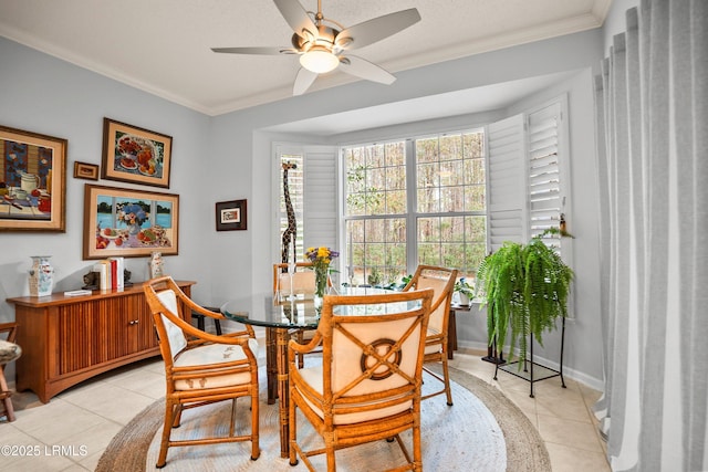 tiled dining room featuring crown molding and ceiling fan