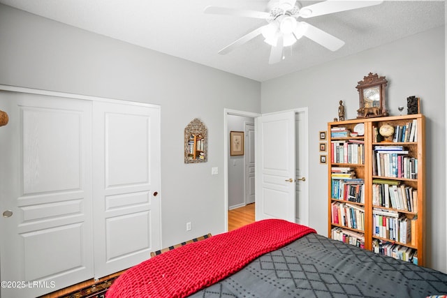 bedroom featuring a closet, ceiling fan, and light wood-type flooring