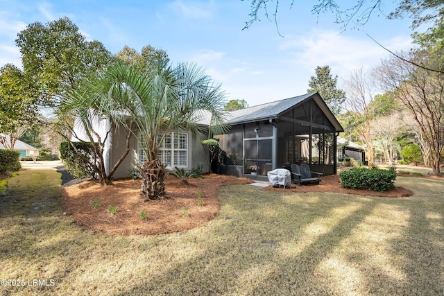 exterior space featuring a yard and a sunroom