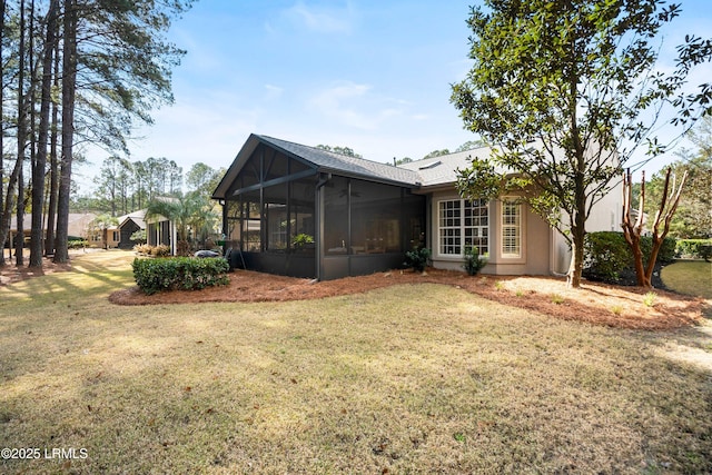 exterior space featuring a yard and a sunroom