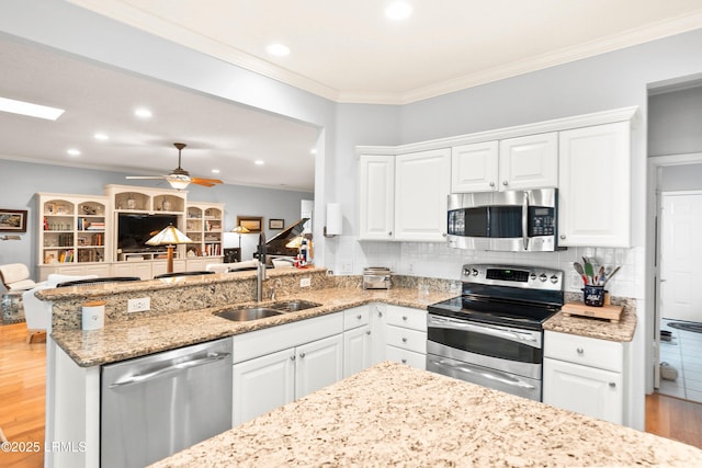 kitchen with sink, stainless steel appliances, and white cabinets