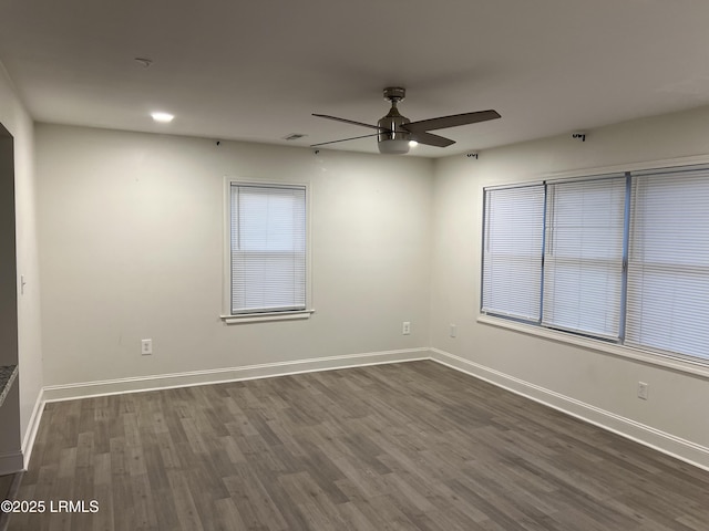 spare room with dark hardwood / wood-style floors and ceiling fan