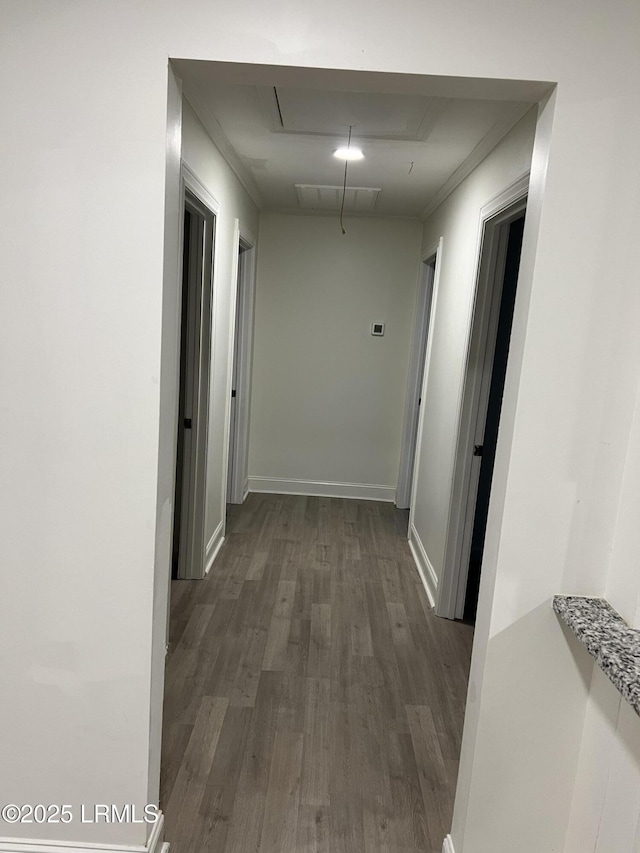 hallway with ornamental molding and dark hardwood / wood-style floors