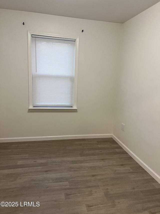 unfurnished room with dark hardwood / wood-style floors