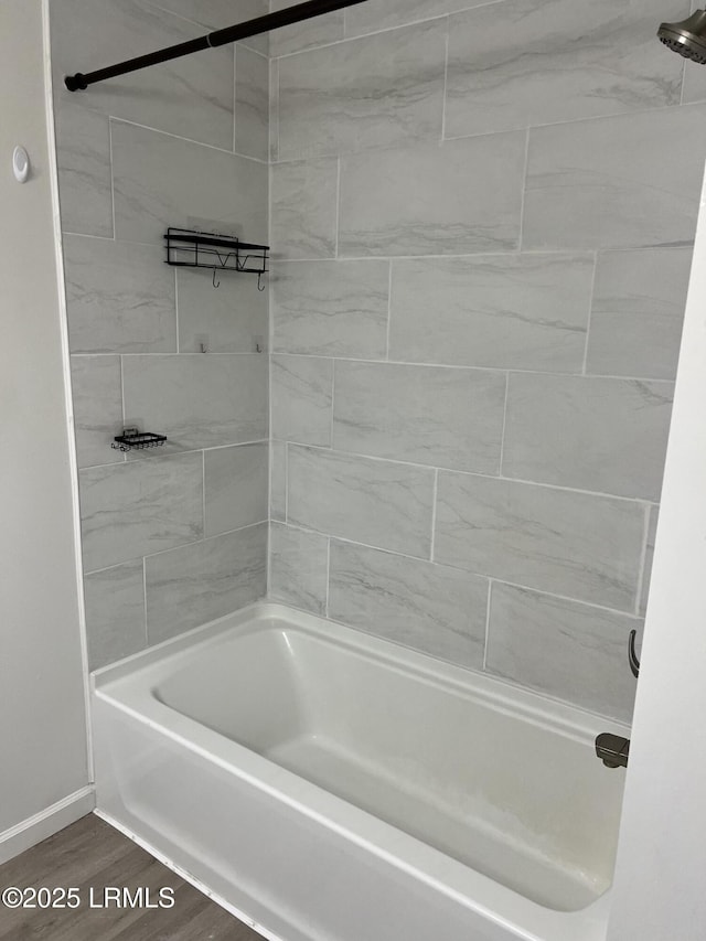 bathroom with wood-type flooring and bathtub / shower combination