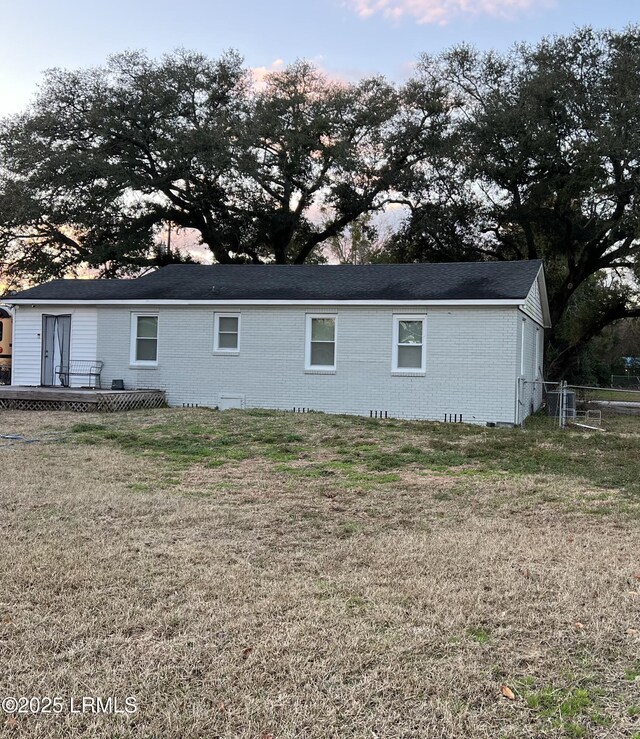 property exterior at dusk with a yard