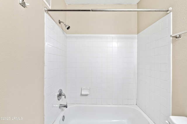 897 Fording Island Rd Unit 301, Bluffton, SC 29910 - bathroom with washtub / shower combination, toilet, and a textured wall