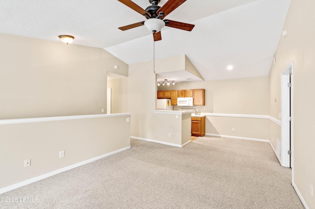 897 Fording Island Rd Unit 301, Bluffton, SC 29910 - unfurnished living room featuring light carpet, ceiling fan, baseboards, and vaulted ceiling