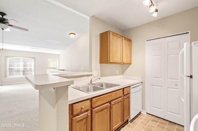 897 Fording Island Rd Unit 301, Bluffton, SC 29910 - kitchen featuring a sink, white appliances, a ceiling fan, light countertops, and a peninsula