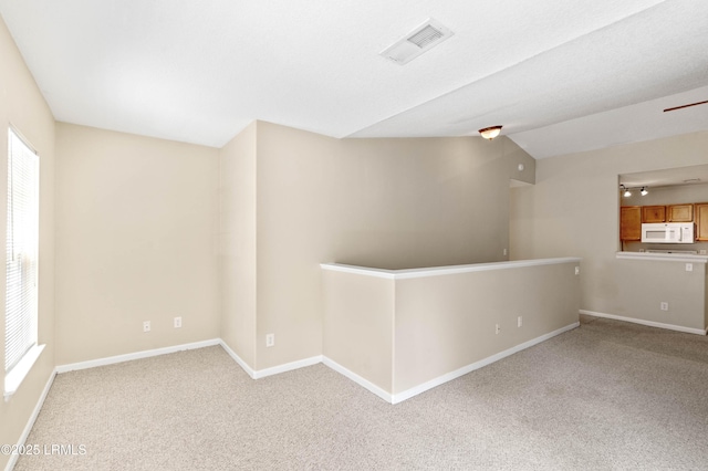 897 Fording Island Rd Unit 301, Bluffton, SC 29910 - empty room featuring carpet floors, baseboards, and vaulted ceiling
