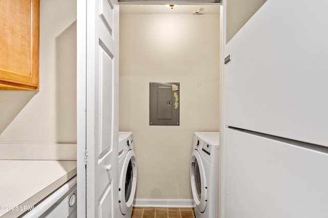 897 Fording Island Rd Unit 301, Bluffton, SC 29910 - washroom featuring washing machine and clothes dryer, electric panel, tile patterned flooring, and baseboards