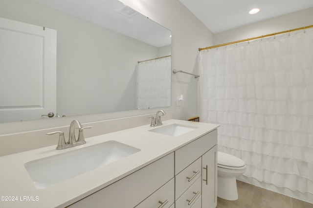 bathroom with tile patterned flooring, vanity, and toilet