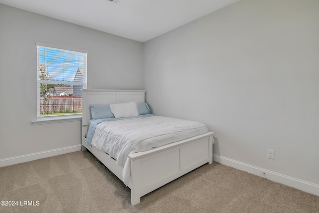 bedroom with light carpet