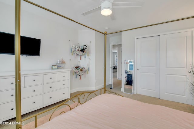 carpeted bedroom with ceiling fan and a closet