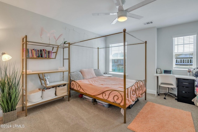 carpeted bedroom with ceiling fan and multiple windows