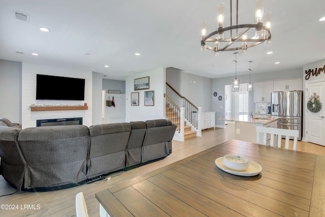 living room featuring sink and light wood-type flooring