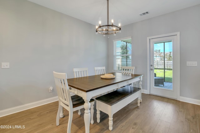 dining space with a notable chandelier and wood-type flooring