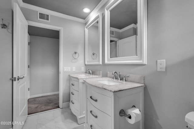 bathroom with ornamental molding and vanity