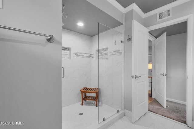 bathroom featuring ornamental molding and a shower with shower door