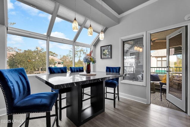 dining space featuring crown molding and dark wood-type flooring