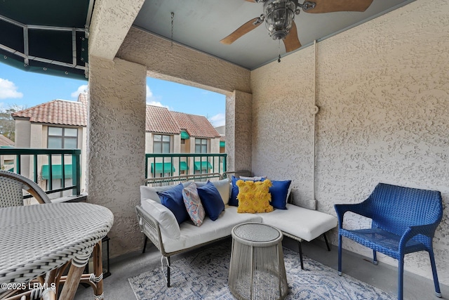 view of patio / terrace with a balcony and ceiling fan