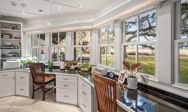 office space with recessed lighting, crown molding, and built in desk