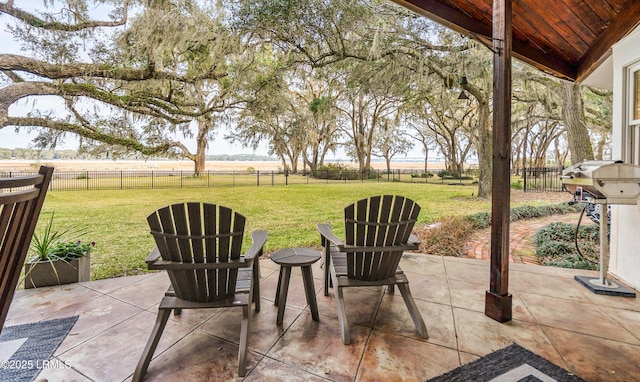 view of patio featuring a fenced backyard, a grill, and a rural view