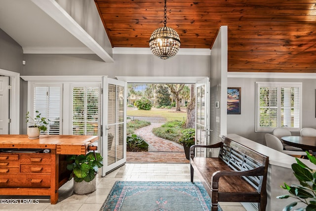 tiled entrance foyer featuring ornamental molding, lofted ceiling, wooden ceiling, and a notable chandelier