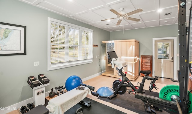 workout area featuring a ceiling fan, coffered ceiling, visible vents, and baseboards